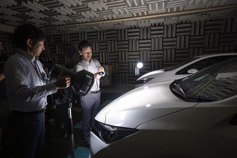 Two Nissan engineers test Nissan's cool paint technology  in laboratory conditions