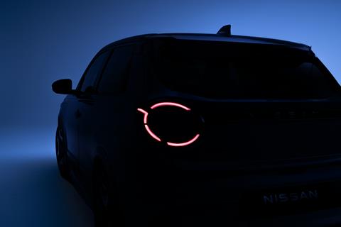 side rear view of Micra in dim light with left headlamps on