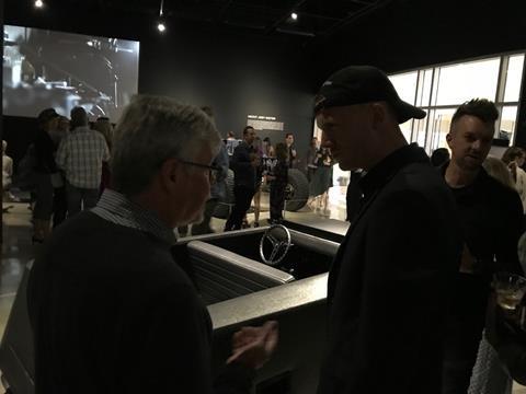 Freeman Thomas (left) and Rem D. Koolhaas discuss car design in the dark